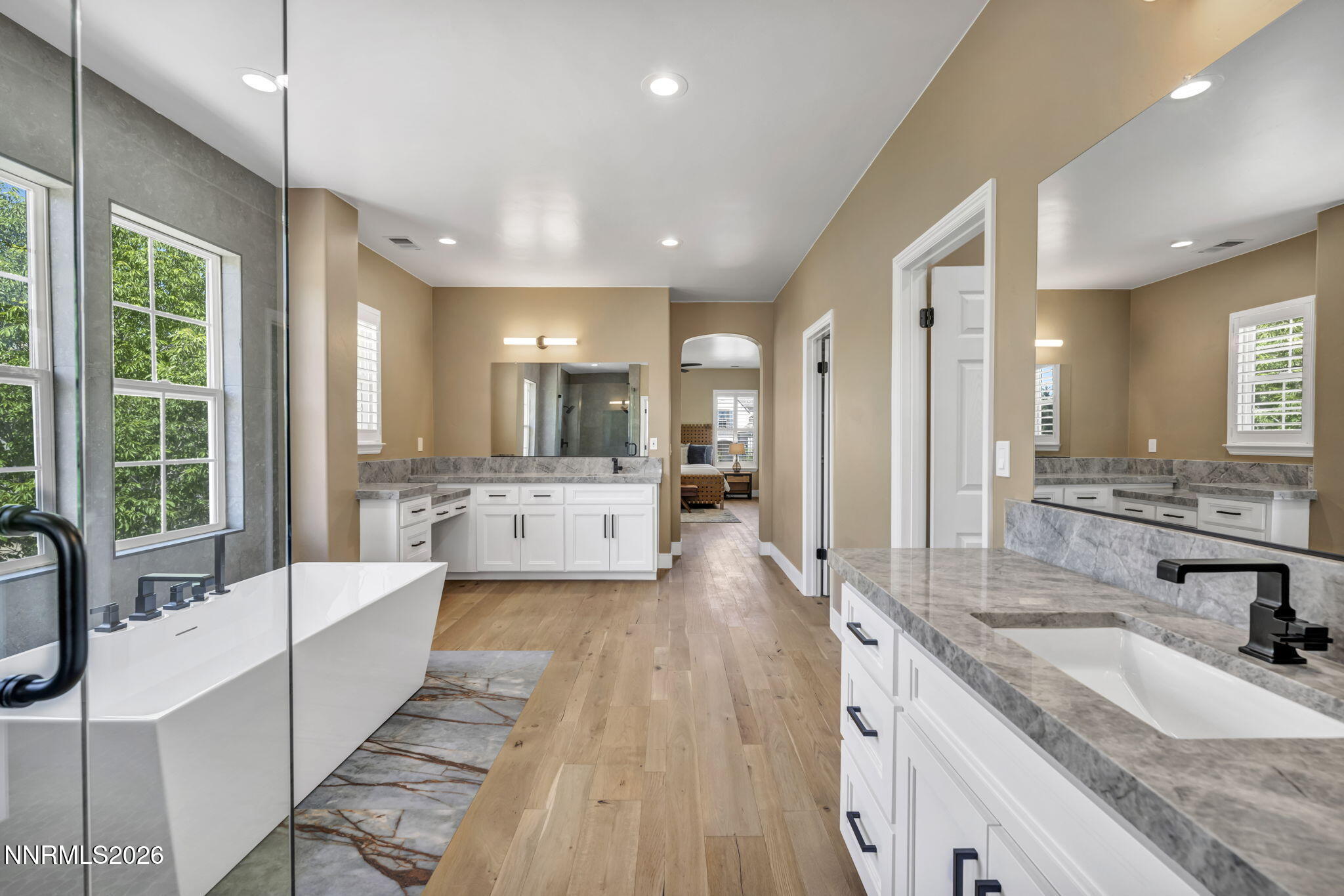 2965 Roundrock Court Reno, NV 89511 - Photo 22 of 40 a large white bathroom with a large mirror vanity and a sink