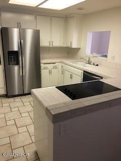 a kitchen with stainless steel appliances a refrigerator sink and cabinets