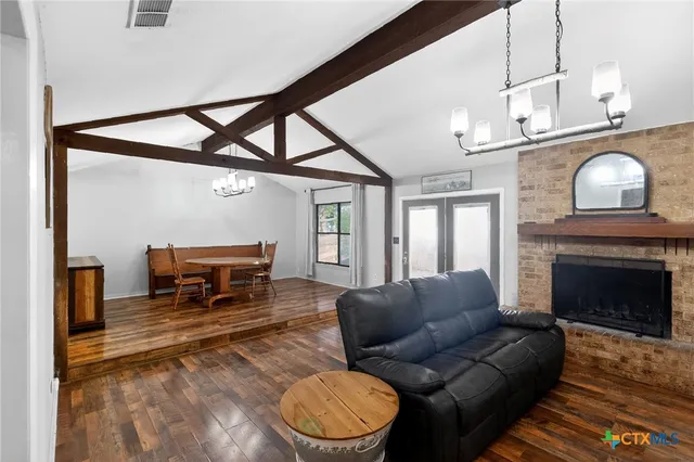 a living room with furniture a fireplace and a table