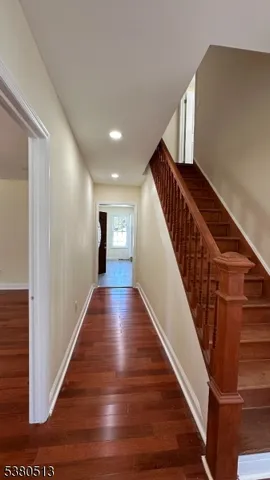 a view of entryway and hall with wooden floor