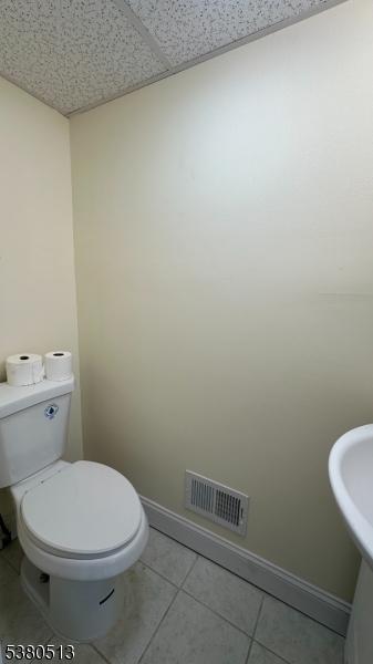 470 Highway 57 Washington, NJ 07882 - Photo 23 of 26 a white toilet sitting next to a white sink and vanity