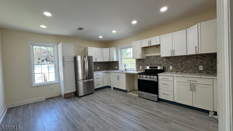470 Highway 57 Washington, NJ 07882 - Photo 4 of 26 a kitchen with a refrigerator and white cabinets