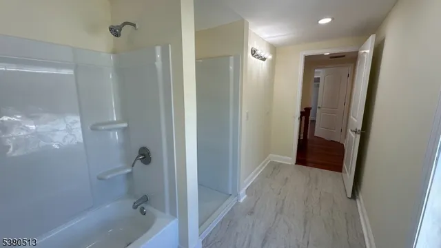 a bathroom with a sink and a glass door shower