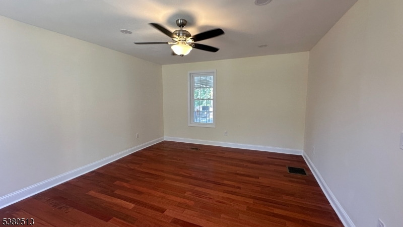 470 Highway 57 Washington, NJ 07882 - Photo 9 of 26 an empty room with wooden floor fan and windows