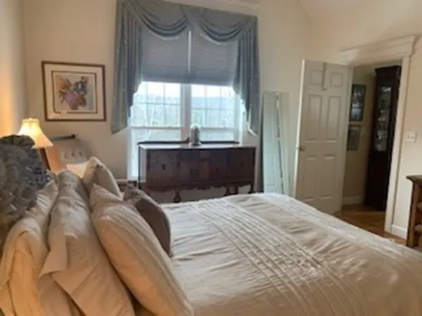 a bedroom with a bed and a window