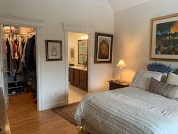 a bedroom with a bed and a painting on the wall