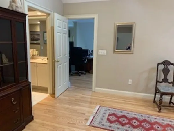 a view of a bedroom with wooden floor and bedroom space