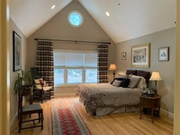 a bedroom with double bed and a window