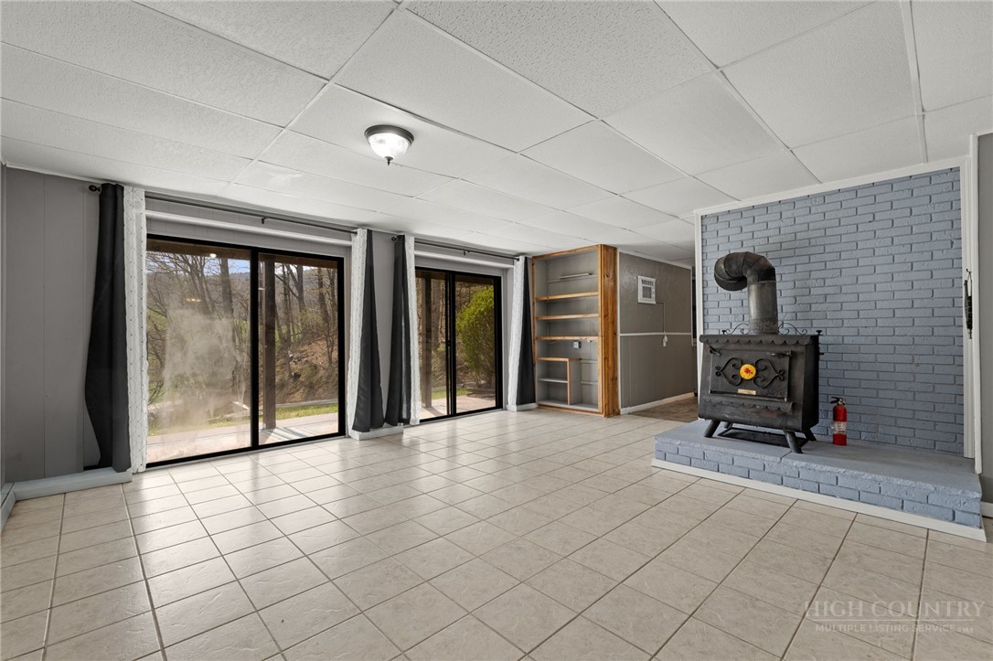 2345 Watauga River Road Sugar Grove, NC 28679 - Photo 25 of 50 a view of a livingroom with a fireplace and glass door