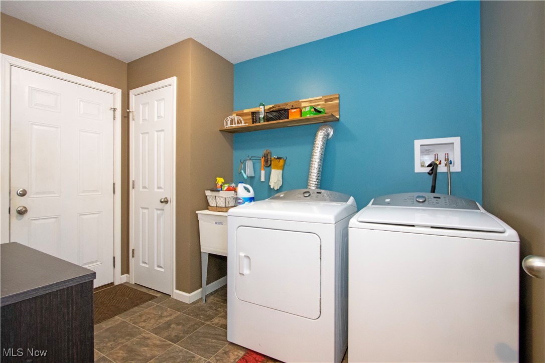8249 Town Line Road Shiloh, OH 44878 - Photo 18 of 34 Laundry area featuring separate washer and dryer and baseboards