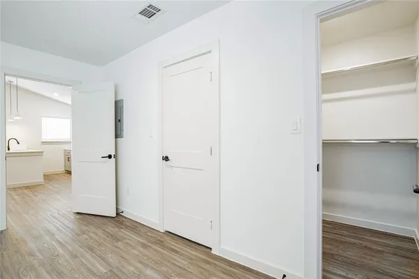 a view of a room with wooden floor