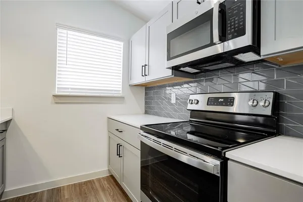 a kitchen with a stove and a microwave