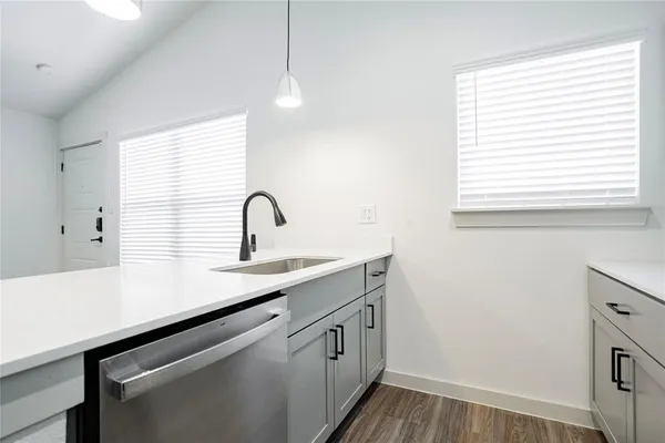 a kitchen with a sink cabinets and window
