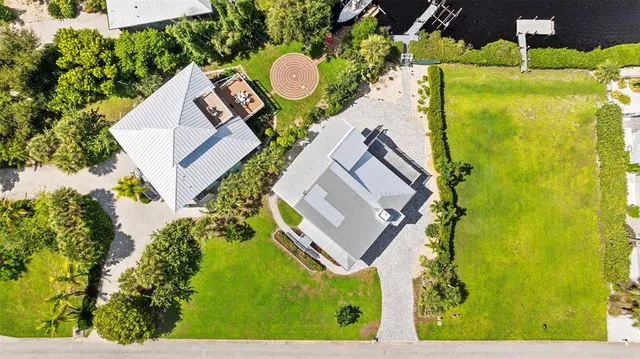 an aerial view of a house with swimming pool and outdoor space