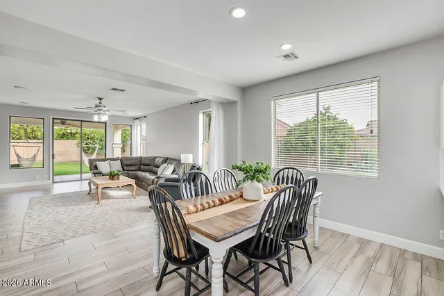 a view of a dining room with furniture and a window
