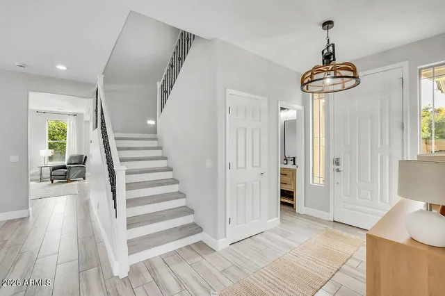a view of a hallway view with wooden floor and staircase