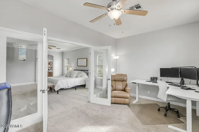 a living room with furniture and a view of bedroom