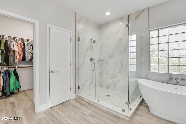 a bathroom with a bathtub and a shower