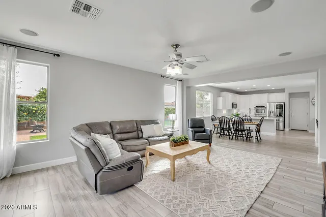 a living room with furniture and a chandelier