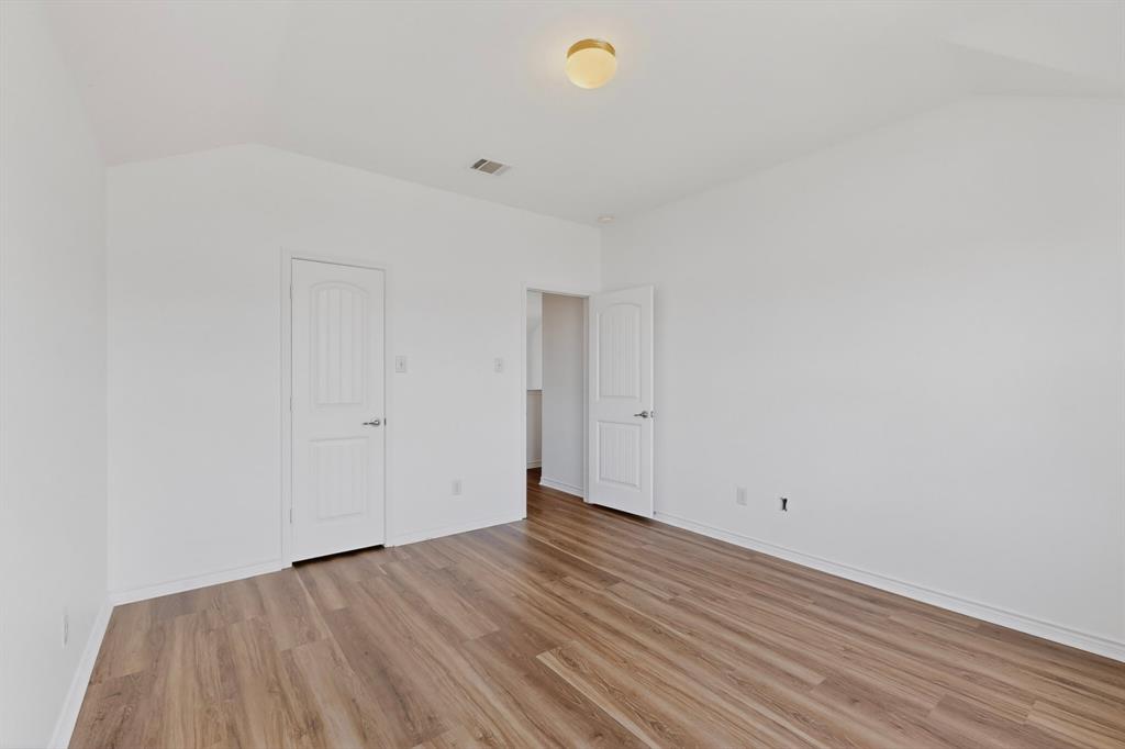 426 Harding Lane Lavon, TX 75166 - Photo 23 of 40 Spacious room with vaulted ceiling and wood-finish flooring