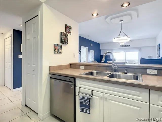 a kitchen with a sink and a refrigerator