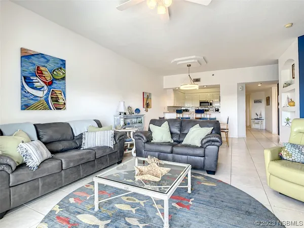 a living room with furniture and kitchen view