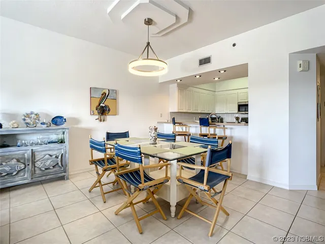 a room with stainless steel appliances kitchen island granite countertop furniture and a view of kitchen
