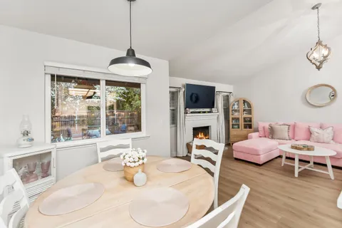 a dining room with furniture window and wooden floor