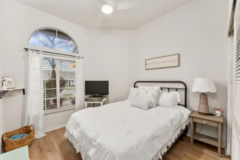 a bedroom with a bed and a window