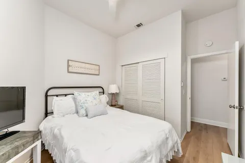 a bedroom with a bed and a flat screen tv