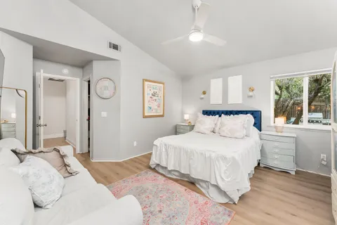 a bedroom with a large bed and a window