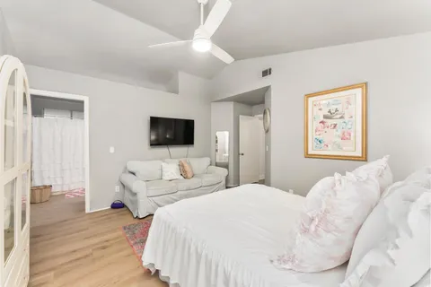 a bedroom with a large bed and a couch