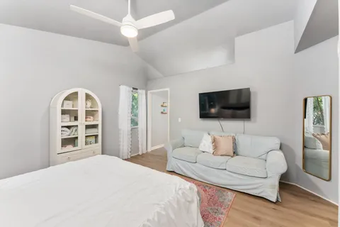 a bedroom with a bed and a flat screen tv