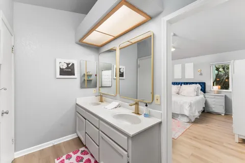 a spacious bathroom with a sink and a mirror