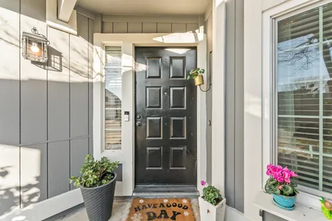 a front view of a house with a potted plant