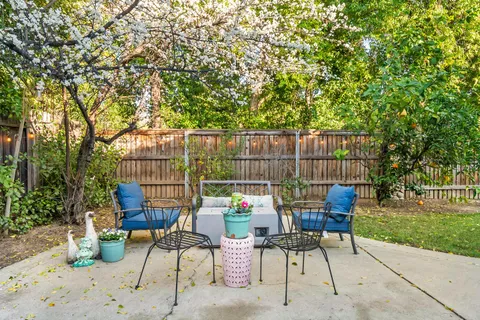 a view of a chairs and table in backyard of the house