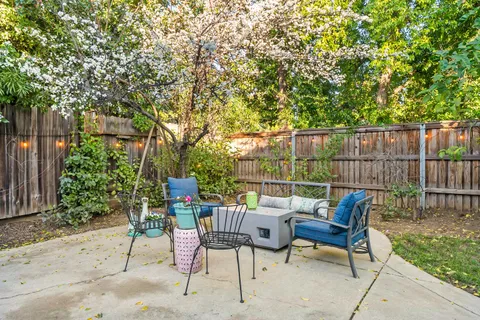 a view of a chairs and table in backyard