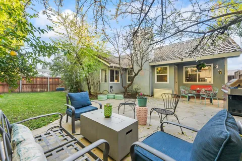 a view of a patio with table and chairs and potted plants