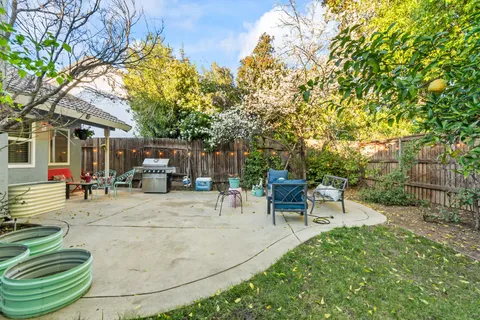a view of a backyard with sitting area