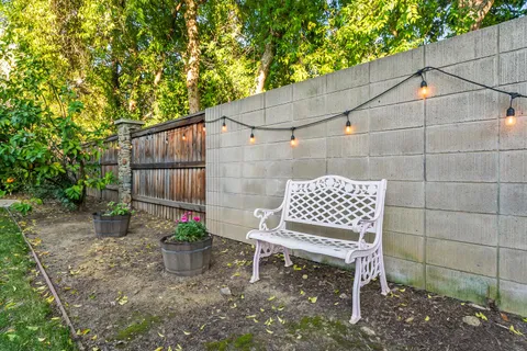 a bench sitting in front of a yard
