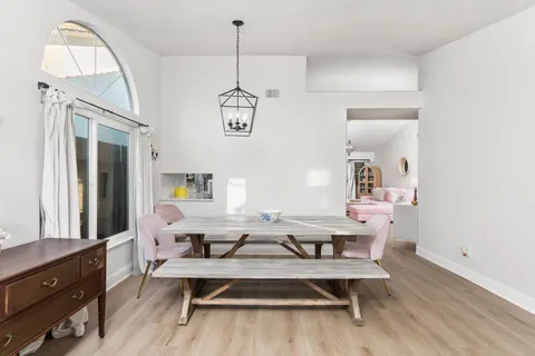 a view of a dining room with furniture wooden floor and a chandelier