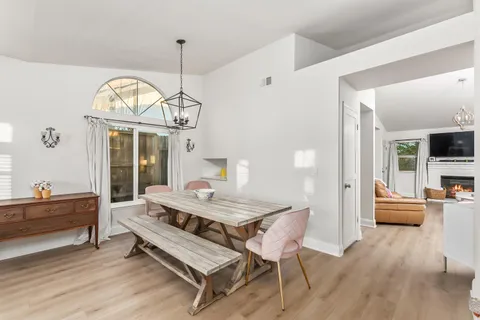 a living room with furniture a table and a chandelier