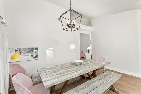 a view of a room with a table and chairs