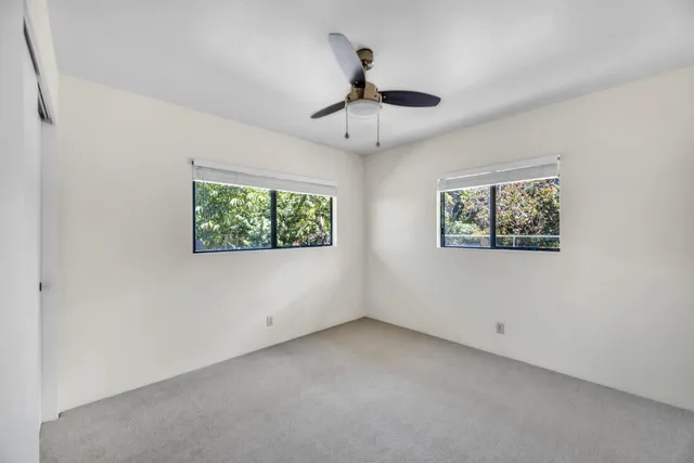 a view of empty room with ceiling fan