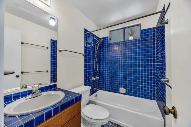 an empty room with a ceiling fan and window