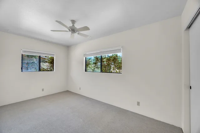 a yellow house with trees in front of it
