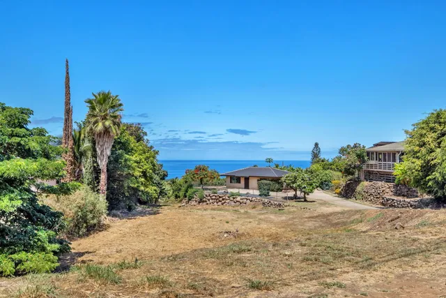 an aerial view of a house with a yard and sitting area