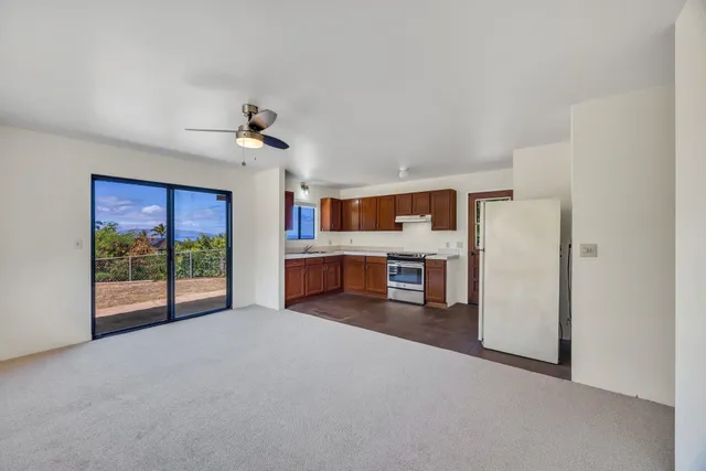 a open kitchen with stainless steel appliances granite countertop a refrigerator and a stove