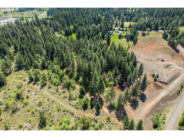 a backyard of a house with a yard and outdoor seating