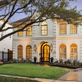 a front view of a building with a garden